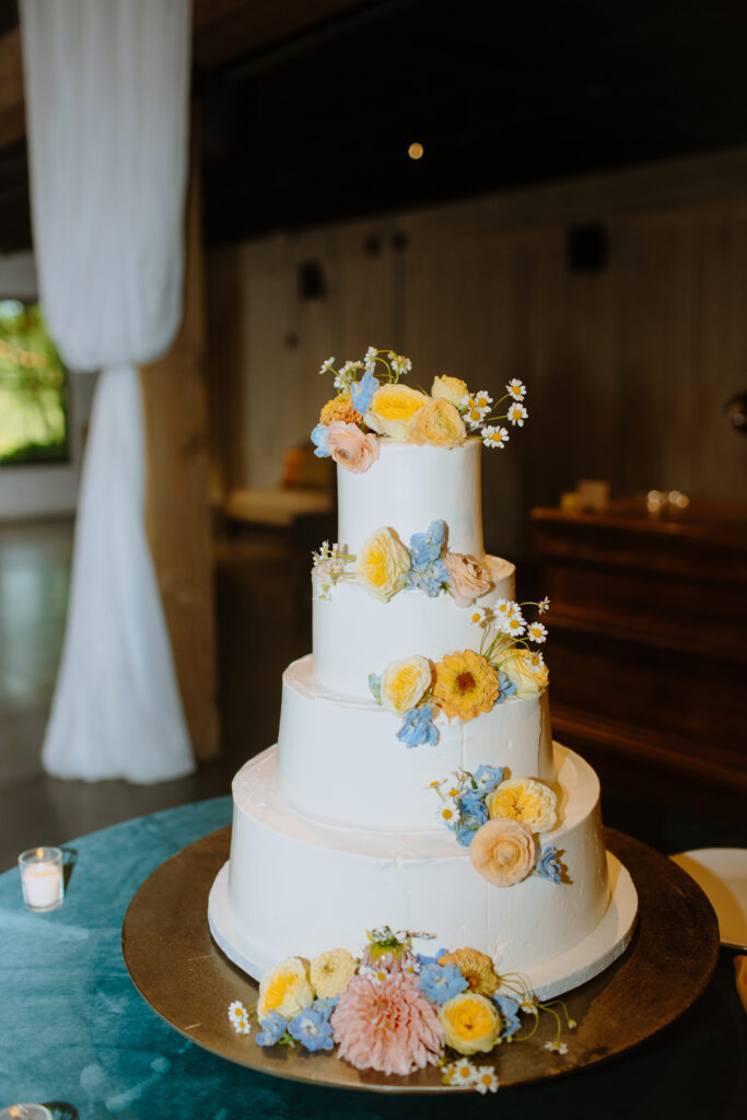 classic white wedding cake with colorful florals 